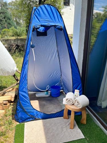 a blue tent with two towels on a table at Avaluna 6 osobe max - shower outside tus spolja in Vrčin