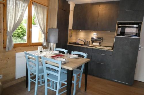 a kitchen with a table and chairs in a kitchen at Apartment for 4 in the center of the village in Saint-Jean-de-Sixt