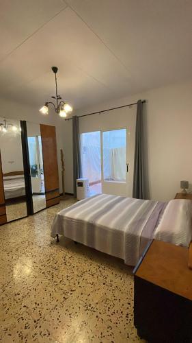 a bedroom with a large bed and a large window at La perle de Benicarló 1 in Benicarló