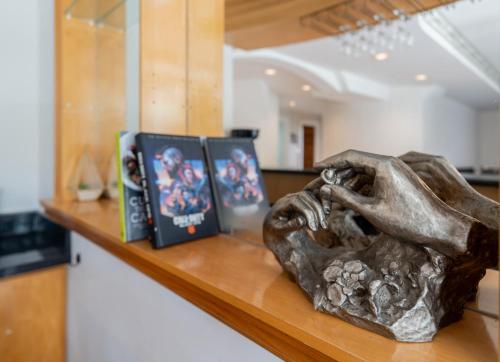 a statue sitting on a counter with books on it at Frybrook in Richmond Hill