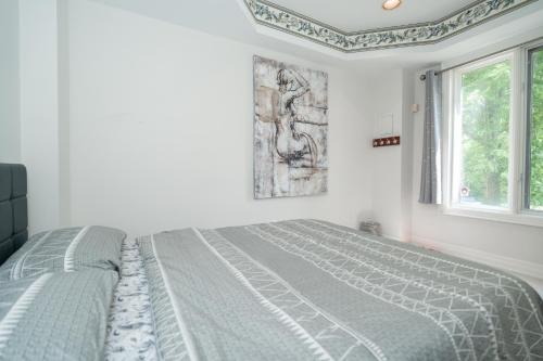a white bedroom with a bed and a window at Frybrook in Richmond Hill