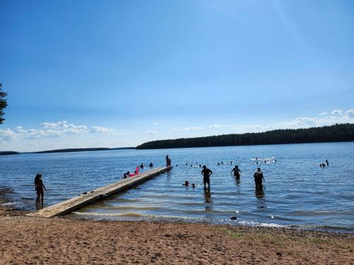a group of people standing on a dock in the water at Cozy room surrounded by nature in Falun