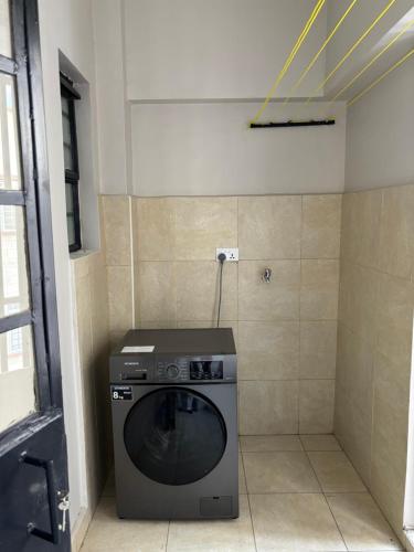 a washer and dryer in a corner of a room at Davinia Haven in Nairobi