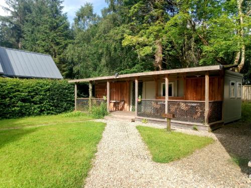 a small house with a path leading to it at Birchwood Guest Lodge in Balmaha