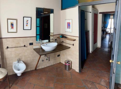 a bathroom with a sink and a toilet at Angolo Del Poeta in Bergamo