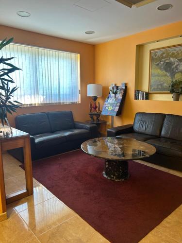a living room with a couch and a table at Hostal Aeropuerto in Madrid