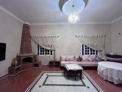 a living room with a couch and a fireplace at Charming villa in Safi in Safi