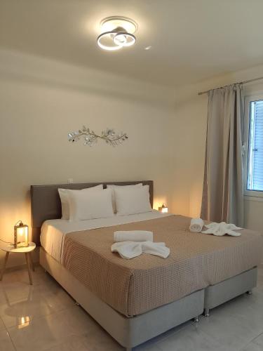 a bedroom with a bed with two towels on it at Euphoria City Homes in Argostoli