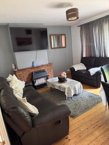 a living room with a couch and a coffee table at Bright Double Room near NewCross Hospital in Fallings Park