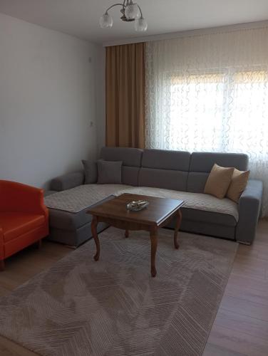 a living room with a couch and a coffee table at Apartmani Mušinbegović in Visoko