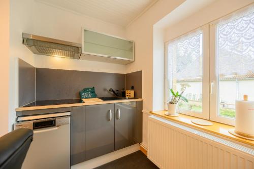 a kitchen with a sink and a window at l'Entracte, enjoy a 3 stars break in Sedan in Sedan