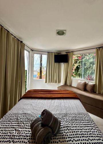 a bedroom with a bed with two towels on it at Cores da pipa flats in Pipa