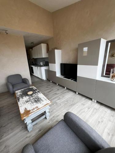 a living room with a couch and a coffee table at L'endroit in Bormes-les-Mimosas