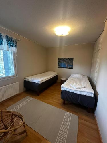 a room with two beds and a window at Jääskän Loma Ratatie 3 asunto 4, Kauhava in Kauhava