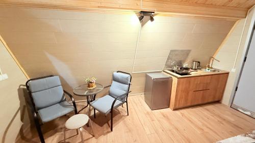 a small kitchen with a table and chairs and a sink at happy pandasN12 in Borjomi