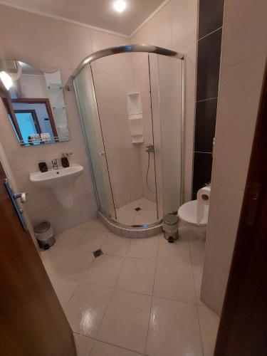 a bathroom with a shower and a sink and a toilet at Lozenets Oasis Beach Home Lila in Lozenets