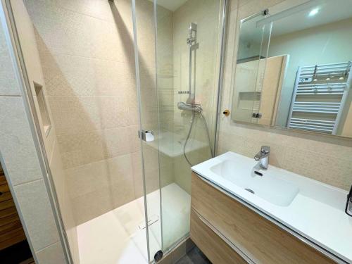 une salle de bain avec un lavabo et une douche dans l'établissement Duplex cosy pour 10 personnes à Reberty 1850, au pied des pistes, avec balcon et parking couvert - FR-1-452-239, aux Menuires