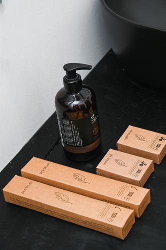 a bottle of soap sitting next to three wooden blocks at ASTREA Relax Suites in Adamas