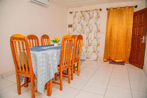 a dining room with a table and four chairs at F2 apartment in Cotonou in Cotonou