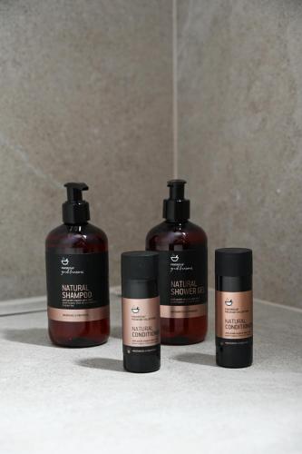 a group of three products sitting on a bathroom counter at ASTREA Relax Suites in Adamas