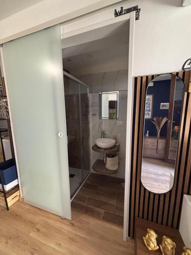 a bathroom with a mirror and a sink at Confini Retreat in Minturno