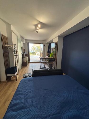 a bedroom with a large blue bed and a table at Confini Retreat in Minturno
