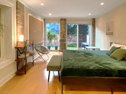 a bedroom with a large bed and a table and chairs at Corporate Housing, Upgraded Condo Downtown Hoboken in Hoboken
