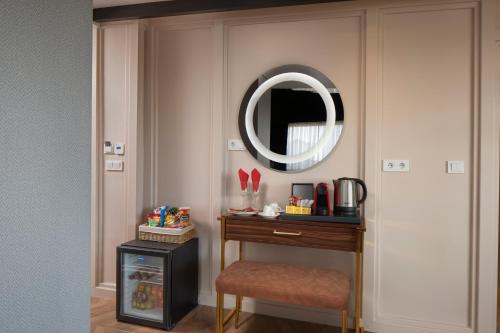 a room with a table and a mirror and a stool at Walton Gardens Pera in Istanbul