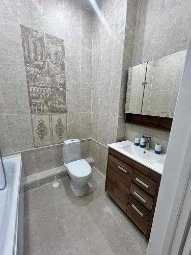 a bathroom with a toilet and a sink at Royal resort in Aktau
