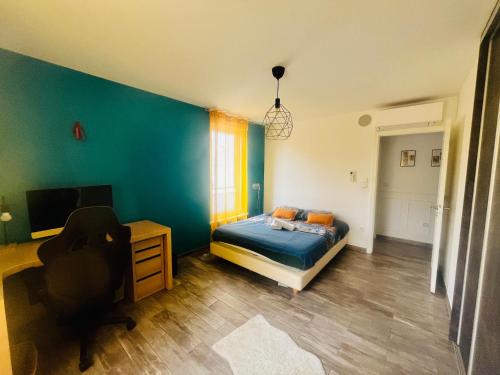 a bedroom with a bed and a desk and a tv at Villa Exclusive in Strasbourg