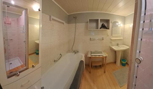 une salle de bain avec une baignoire et un lavabo dans l'établissement Les VIGNEAUX Hautes Alpes, Appartement 4 personnes, avec belle terrasse panoramique, à Les Vigneaux