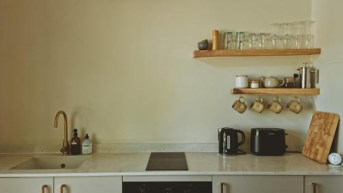 a kitchen with a sink and a counter top at The Lodge, Burniston in Scarborough