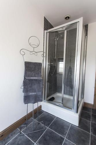 a room with a glass window and a chair at Lincoln Holiday Retreat Lodge with Private Hot Tub in Lincoln