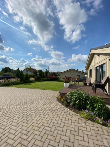 a patio with a brick driveway and a house at Family house in Valmiera