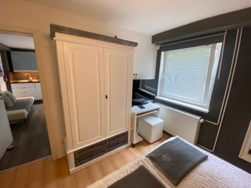 a room with a white cabinet and a window at City Holiday Apartments Berlin in Berlin