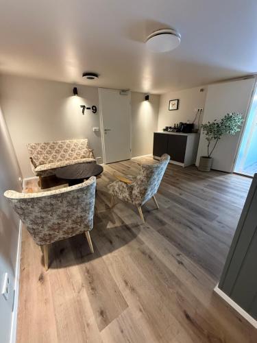 a living room with two chairs and a table at Hótel Gerpir in Neskaupstaður