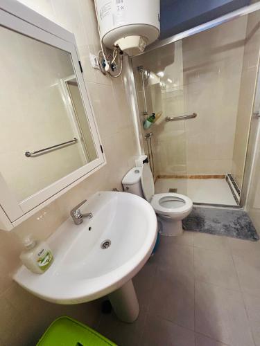 a bathroom with a sink and a toilet at Neptuno 12 in Caleta De Fuste