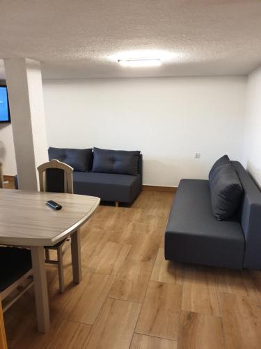 a living room with a couch and a table at Apartamenty Zator Energy Rest in Zator