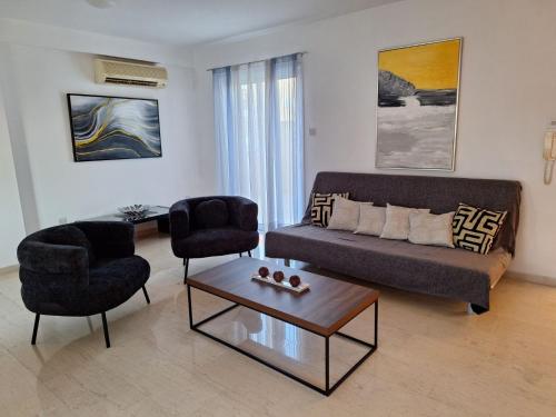 a living room with a couch and two chairs and a table at City Sunshine, Strovolos - Nicosia in Nicosia