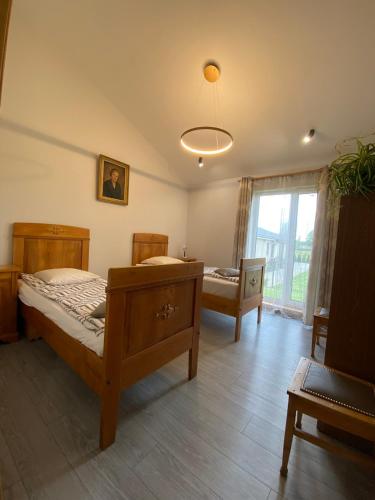 a bedroom with a bed and a table and a window at Family house in Valmiera