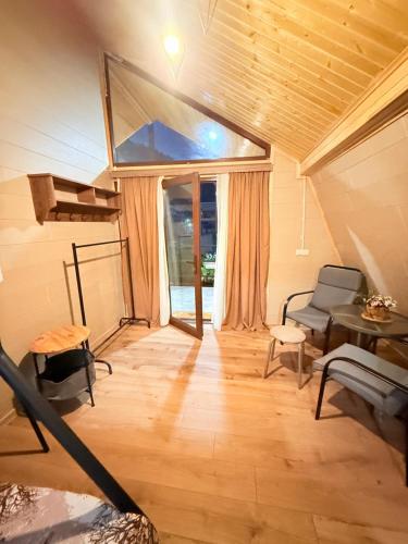 a living room with a bed and a table and chairs at happy pandasN12 in Borjomi