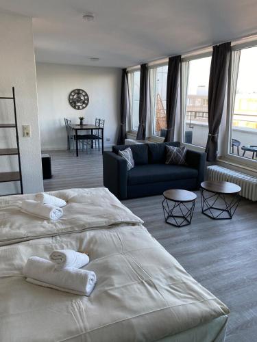 a bedroom with a large bed and a living room at City Appartment in Essen