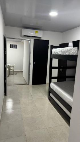 a room with two bunk beds and a hallway at Mami Yola in Valledupar
