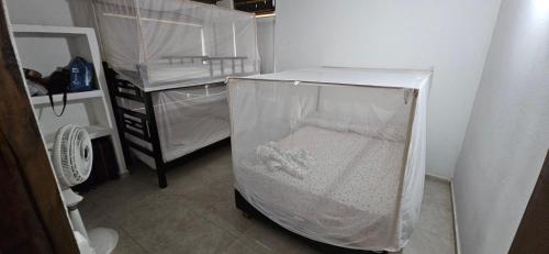 a small room with a bed in a plastic container at Indigo Palomino Beautiful House in Palomino