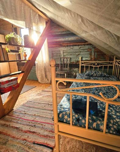 a bedroom with a bunk bed in a room at Gluosnių vila - Adutiškio pirtis in Švenčionys