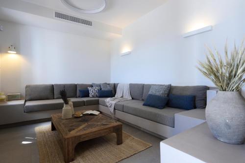 a living room with a couch and a coffee table at ANOTERRA VILLAS -Astris in Ambelas