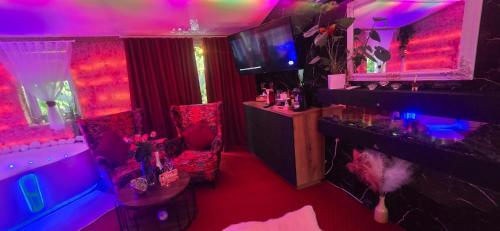 a room with pink and purple lights and a fish tank at APARTAMENT Solny SPA in Rzeszów