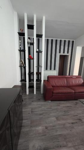 a living room with a red couch in a room at Casa Morgana, a 2 passi dal mare in Badolato Stazione