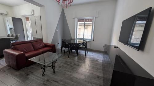 a living room with a couch and a table at Casa Morgana, a 2 passi dal mare in Badolato Stazione