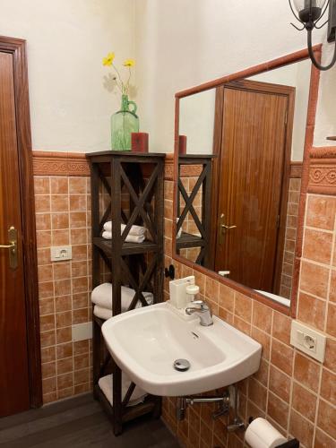 a bathroom with a sink and a mirror at Casa Brisa Abades in Abades
